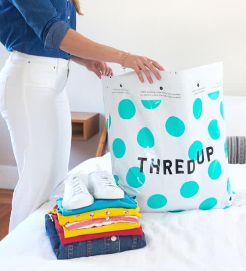 Woman with thredUP cleanout kit